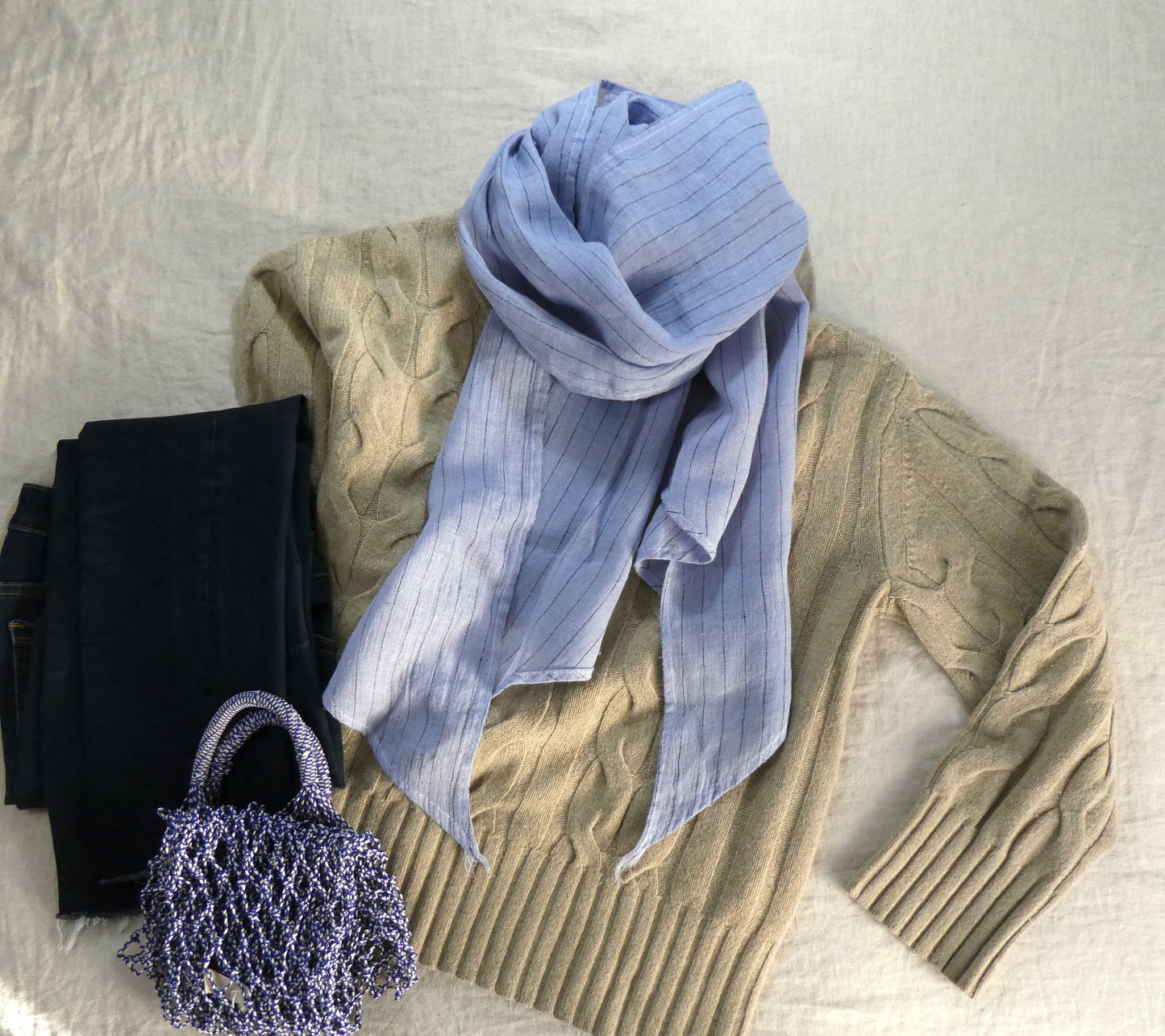 Light blue linen scarf with outfit lay flat display.