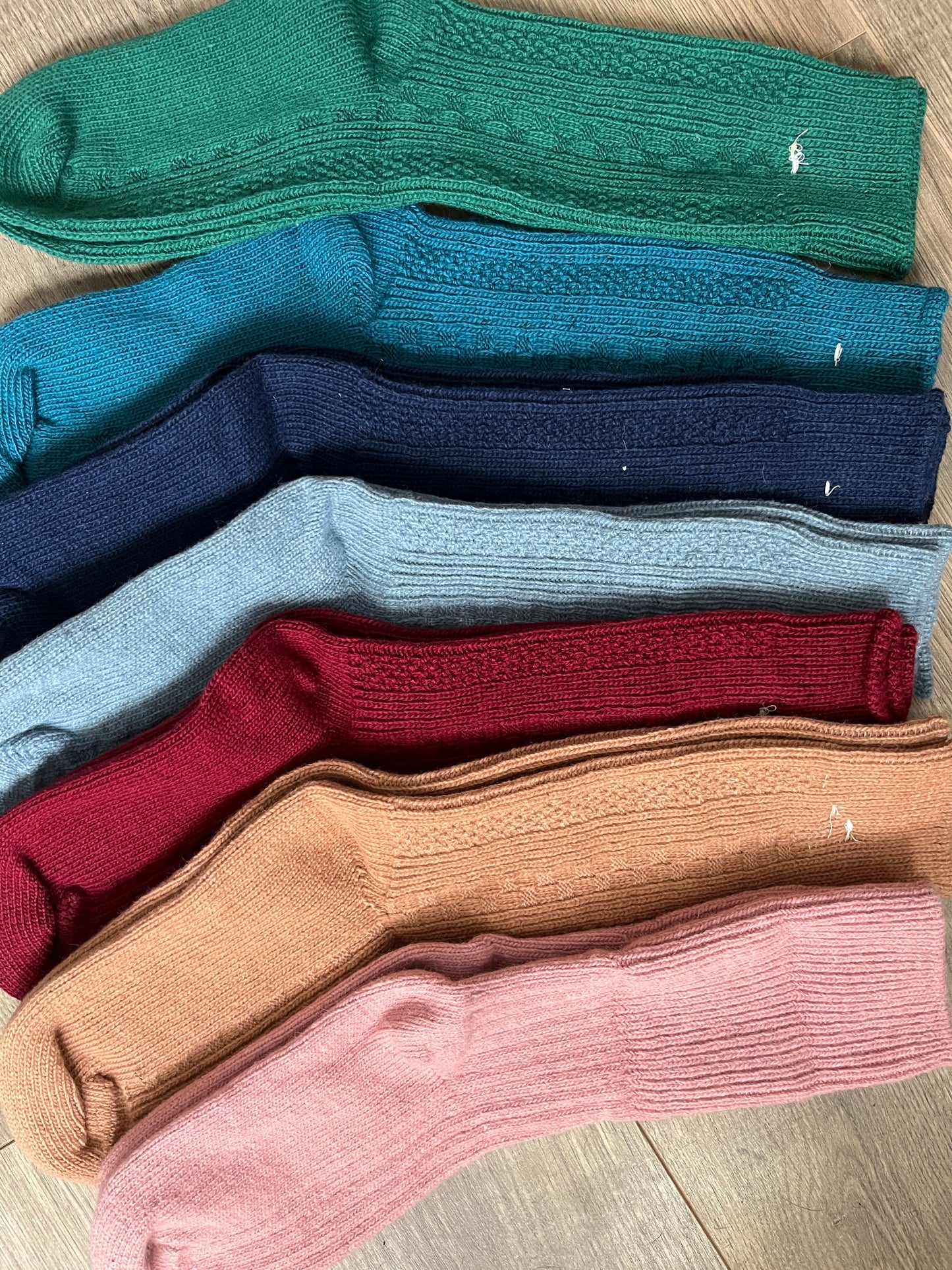 An array of colors of 100% merino wool crew socks.