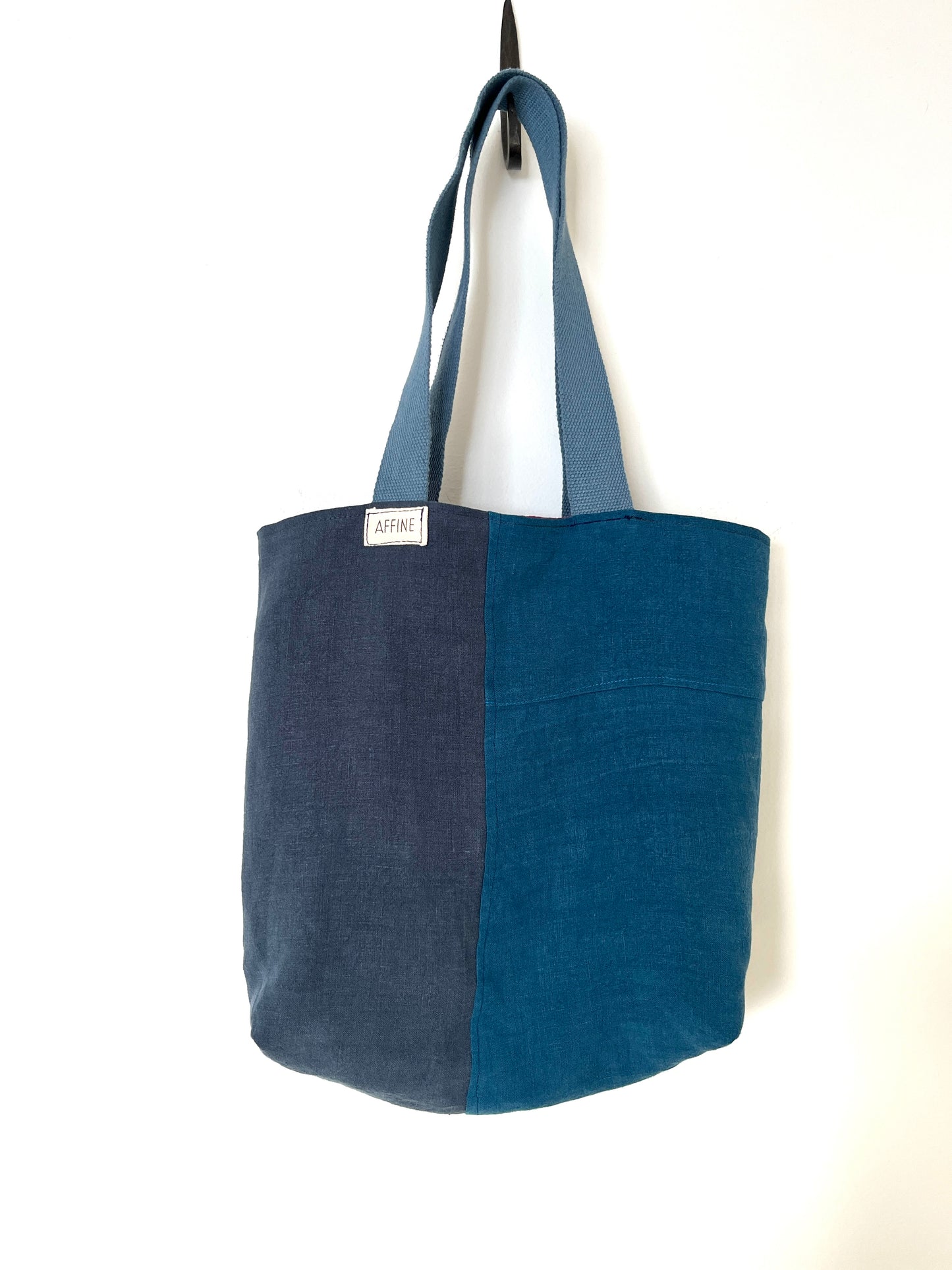 The blue side of a reversible linen tote bag, showing three shades of blue.