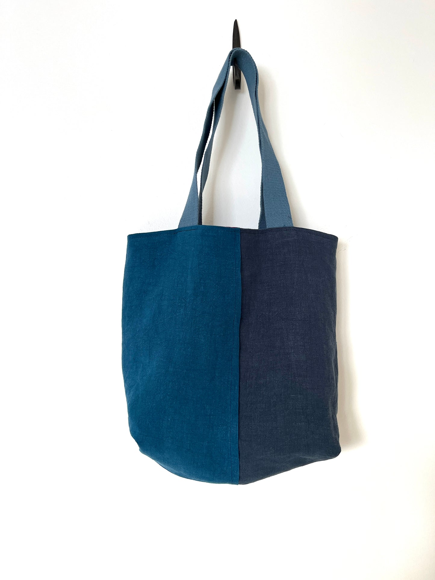 The blue side of a reversible linen tote bag, showing three shades of blue.