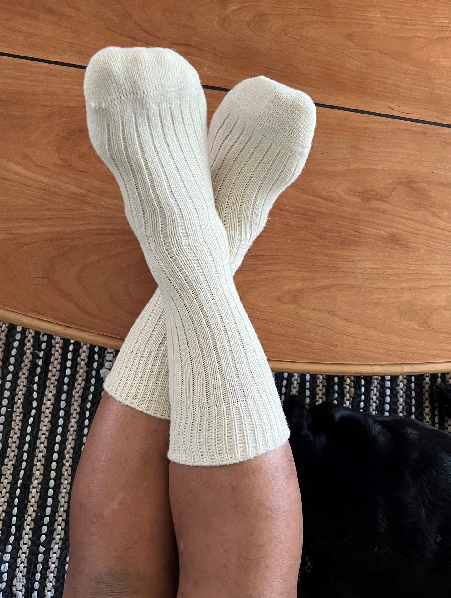 Off-white merino wool socks on a man's feet.