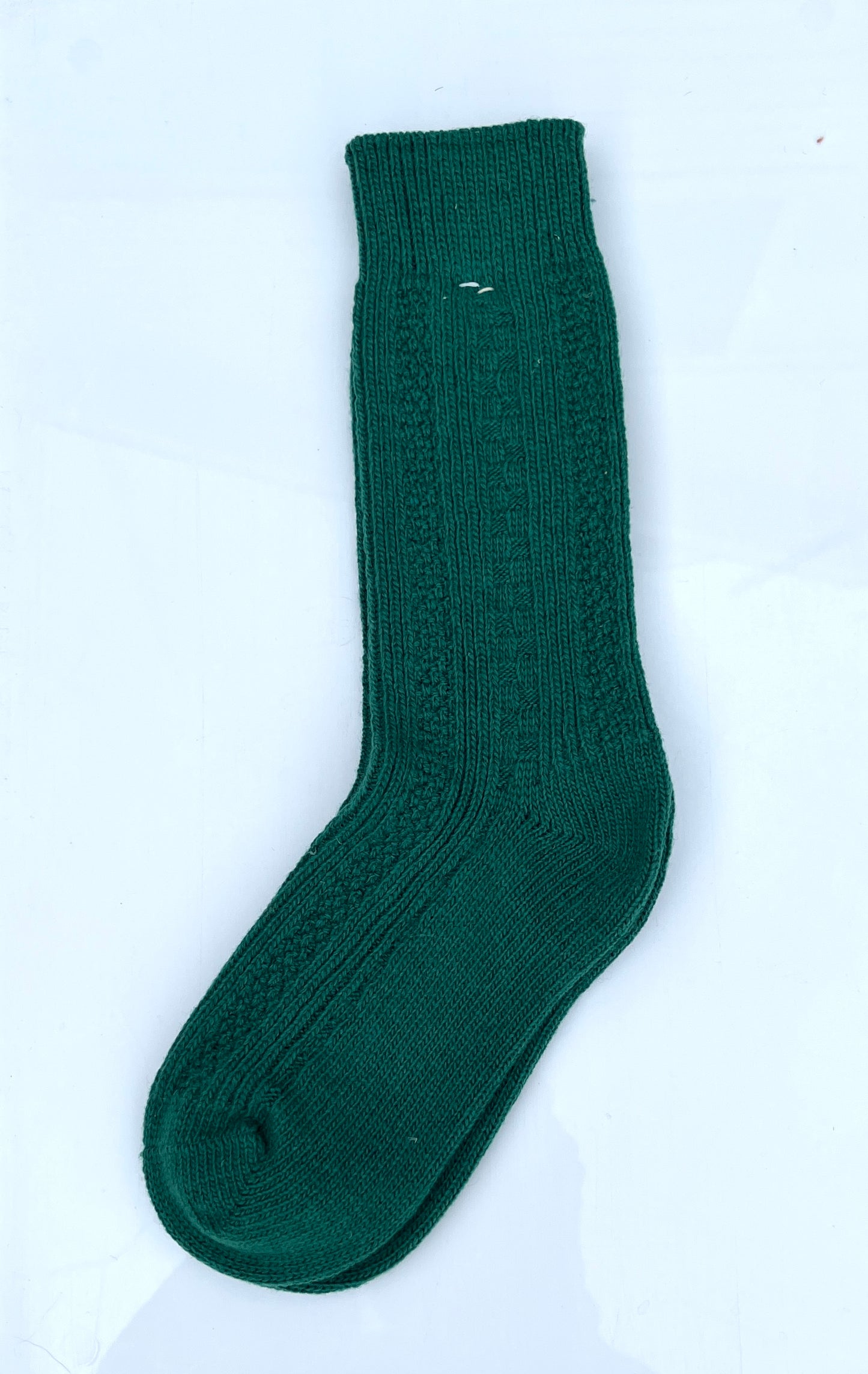 Dark green color merino wool crew socks, laying flat.