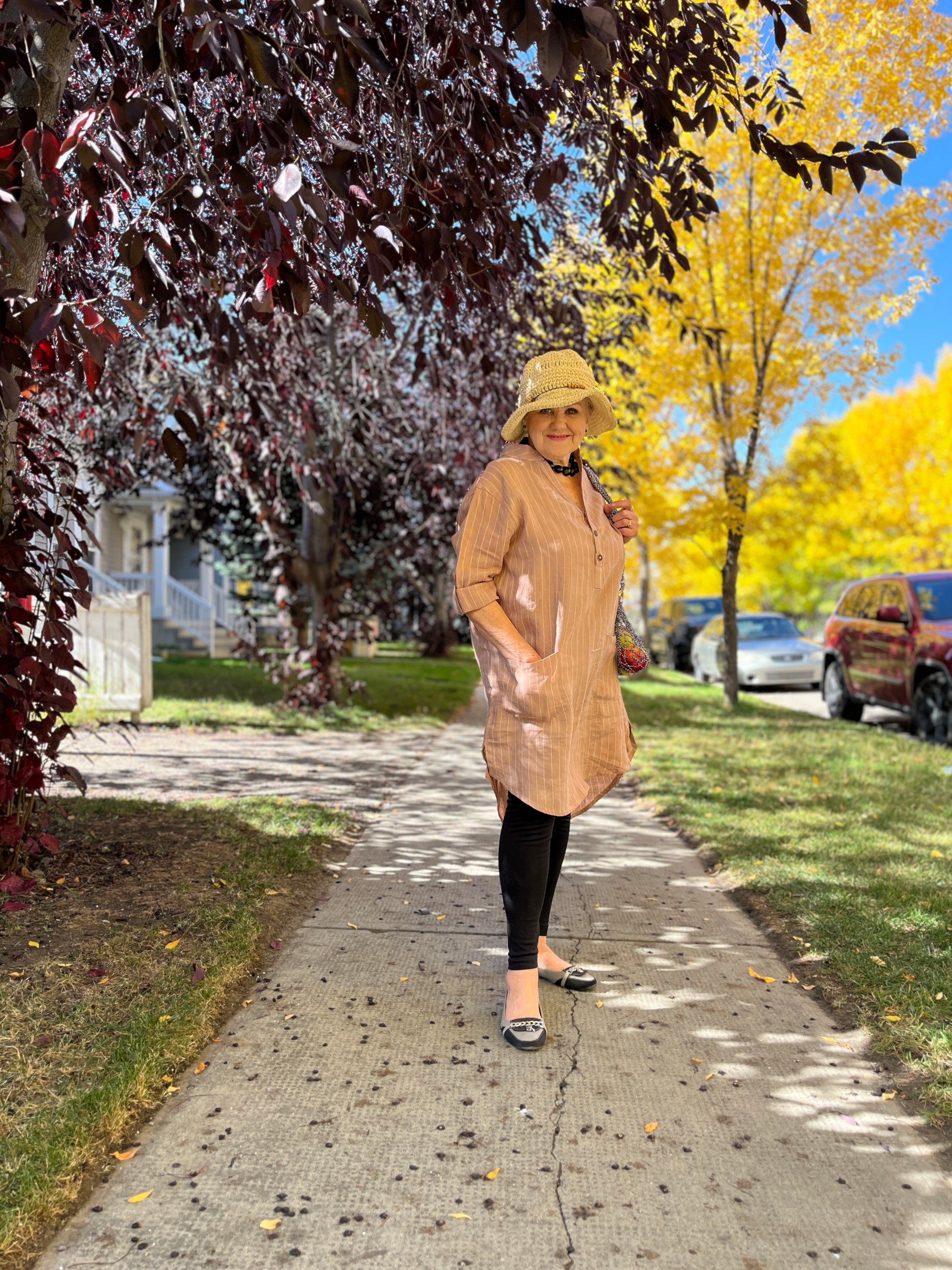 Woman wearing our linen shirt dress over tights.