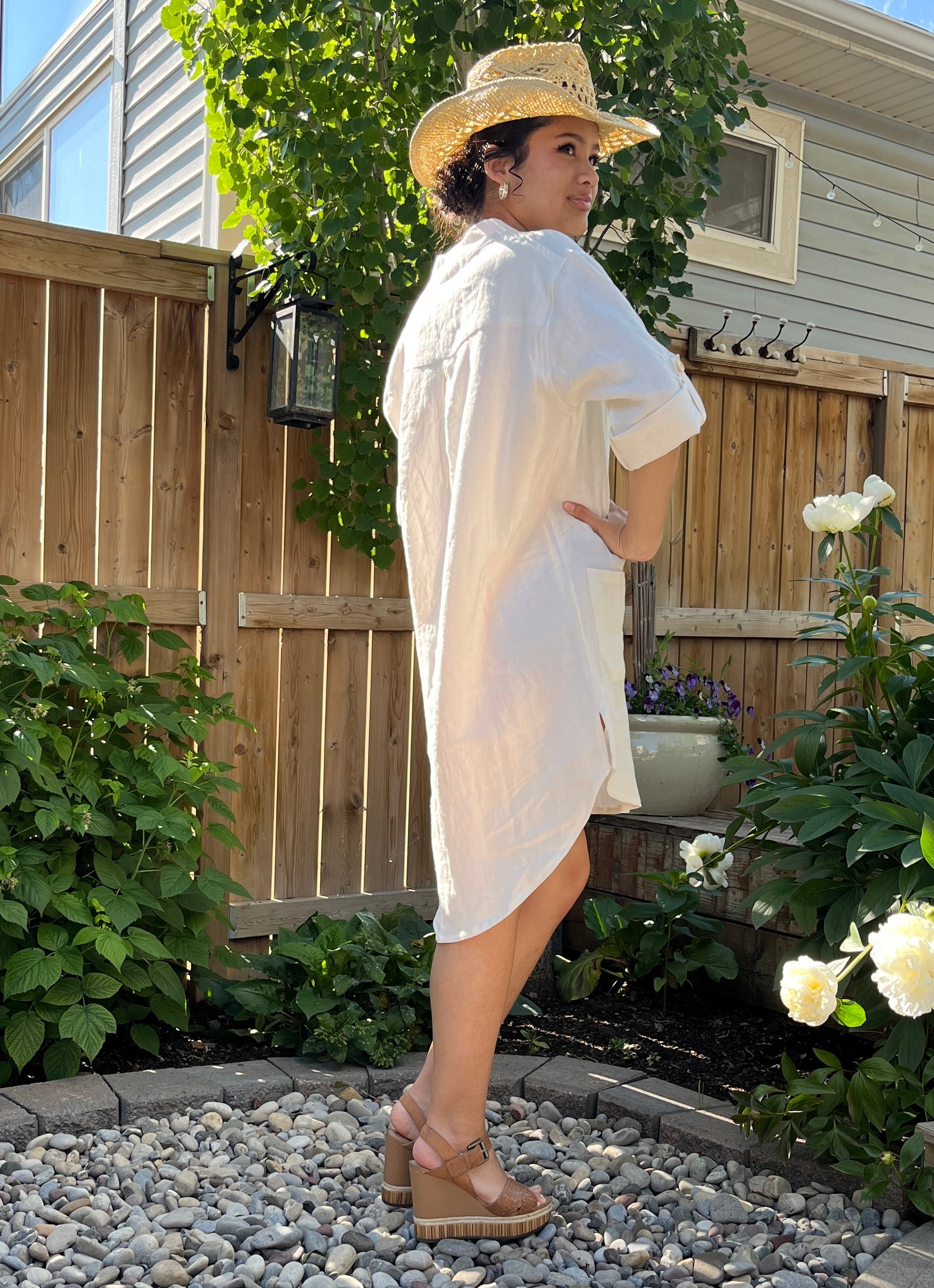 Woman wearing our off-white linen shirt dress in short version.