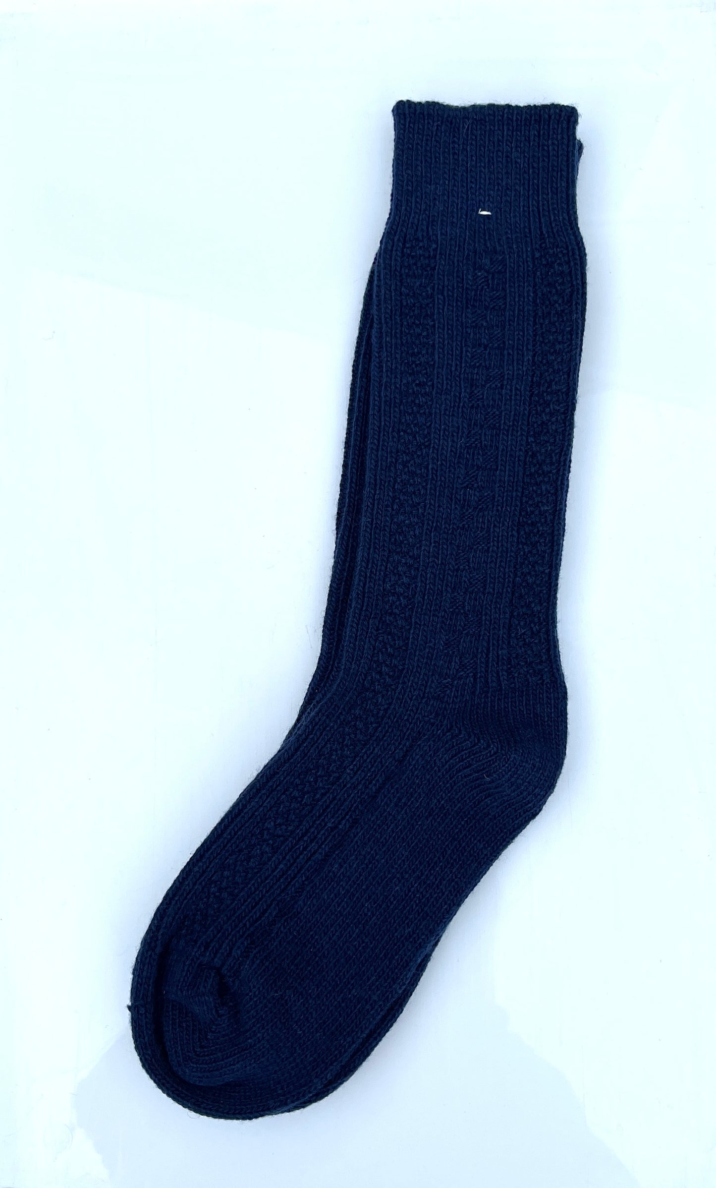 Navy blue color merino wool crew socks, laying flat.